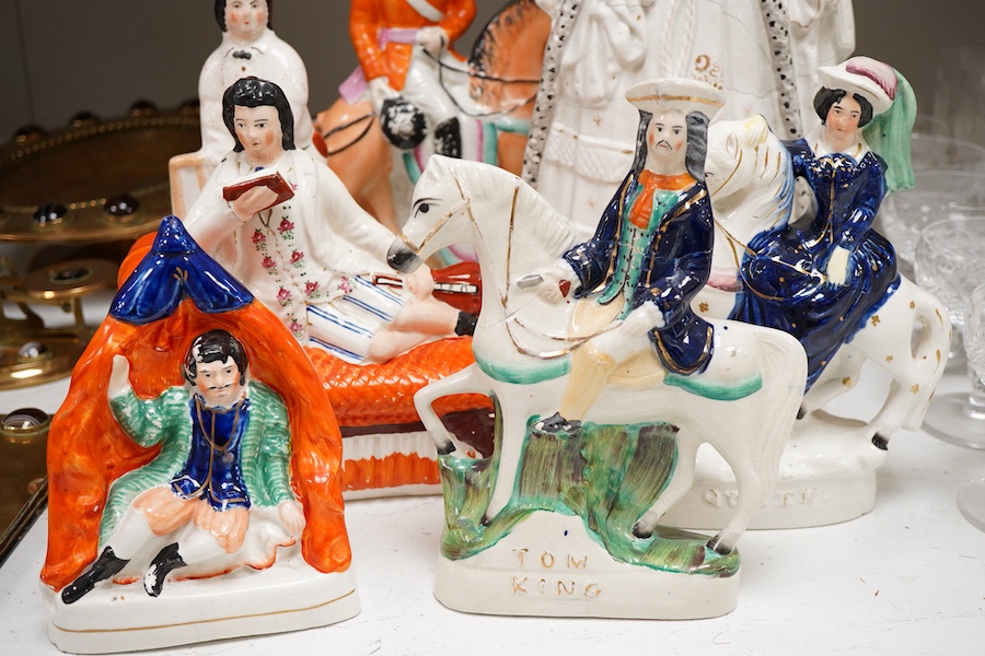 A collection of seven Staffordshire figures, including Queen Victoria - 45cm high, a cricketer, a boy reading, Tom King etc